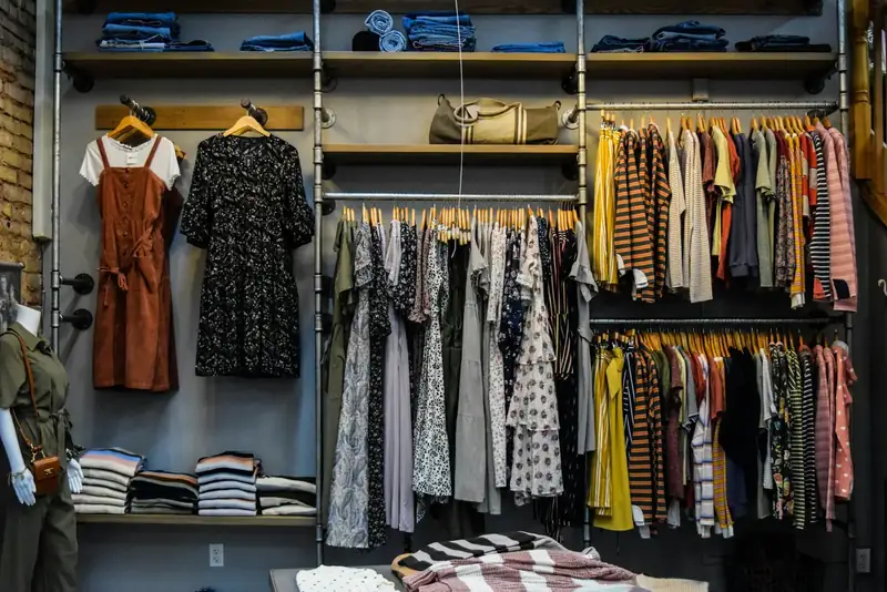 Retail fixtures and folded apparel on open tables